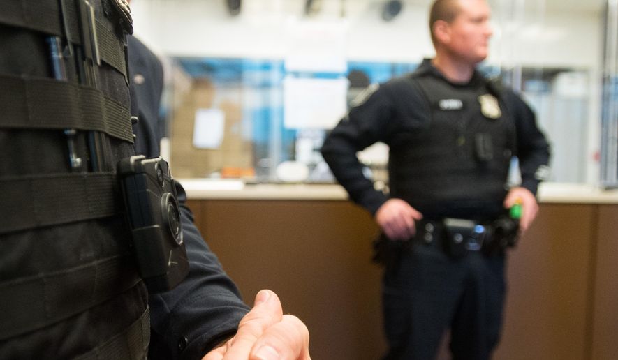Bay City Public Safety Officer Jason Richnak wears a body camera for his shift Wednesday, March 25, 2015 at Bay County Law Enforcement Center in Bay City, Mich. Officers will wear two body-worn cameras from different brands during the pilot program. A number of other Michigan departments are adding body cameras or considering the equipment. (AP Photo/The Bay City Times, Yfat Yossifor) LOCAL TELEVISION OUT; LOCAL INTERNET OUT