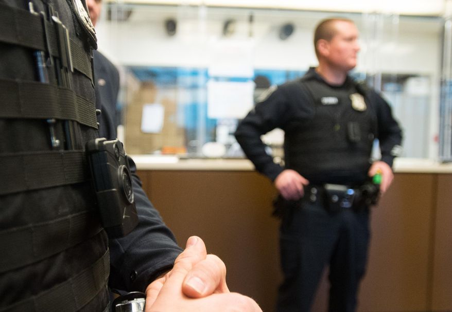 Bay City Public Safety Officer Jason Richnak wears a body camera for his shift Wednesday, March 25, 2015 at Bay County Law Enforcement Center in Bay City, Mich. Officers will wear two body-worn cameras from different brands during the pilot program. A number of other Michigan departments are adding body cameras or considering the equipment. (AP Photo/The Bay City Times, Yfat Yossifor) LOCAL TELEVISION OUT; LOCAL INTERNET OUT