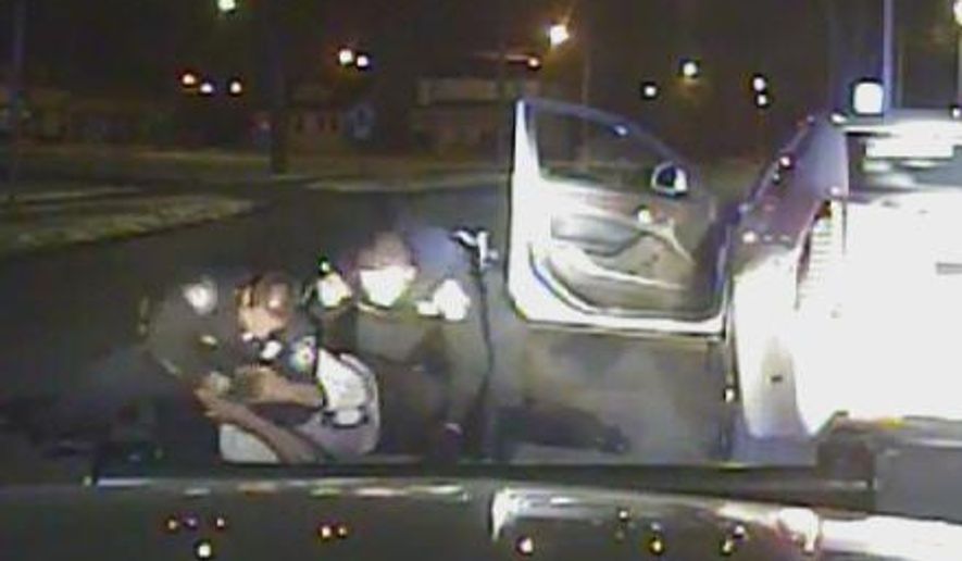 In this Jan. 28, 2015, frame from a dashcam video provided by the Inkster Police Department, an officer punches Floyd Dent many times in the head while another officer tries to handcuff Dent, who is on the ground in Inkster, Mich. Dent's face and shirt were bloodied. Police say Dent disregarded stop signs and refused to pull over, then resisted arrest and threatened them. (AP Photo/Inkster Police Department via Detroit News)