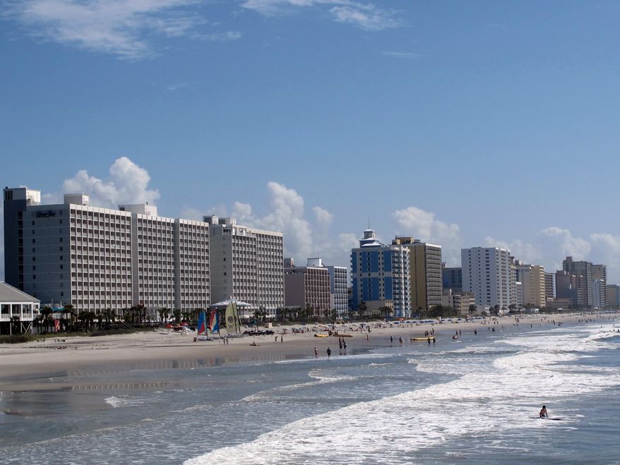 FILE - This May 22, 2013 file photo shows vacationers enjoying the beach in Myrtle Beach, S.C. The U.S. Census Bureau announced on Thursday, March 26, 2015 that the Myrtle Beach metropolitan area was the second-fastest growing metropolitan area in the nation from July of 2013 to July, 2014. The Villages, Florida, ranked as the nation's fastest-growing metro area last year. (AP Photo/Bruce Smith, File)