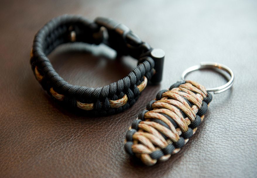FOR RELEASE SATURDAY, MARCH 28, 2015, AT 1:32 A.M. AKDT. - This photo taken on Friday, March 6, 2015, shows two of Grayson Davey's products, the Alaska Survival Bracelet and the Firebug Keychain. (AP Photo/Alaska Dispatch News, Marc Lester) KTUU-TV OUT; KTVA-TV OUT; THE MAT-SU VALLEY FRONTIERSMAN OUT
