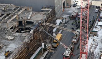 At least 30 people were injured and others could be trapped in a five-story Manhattan building that caught fire and collapsed Thursday, New York police said