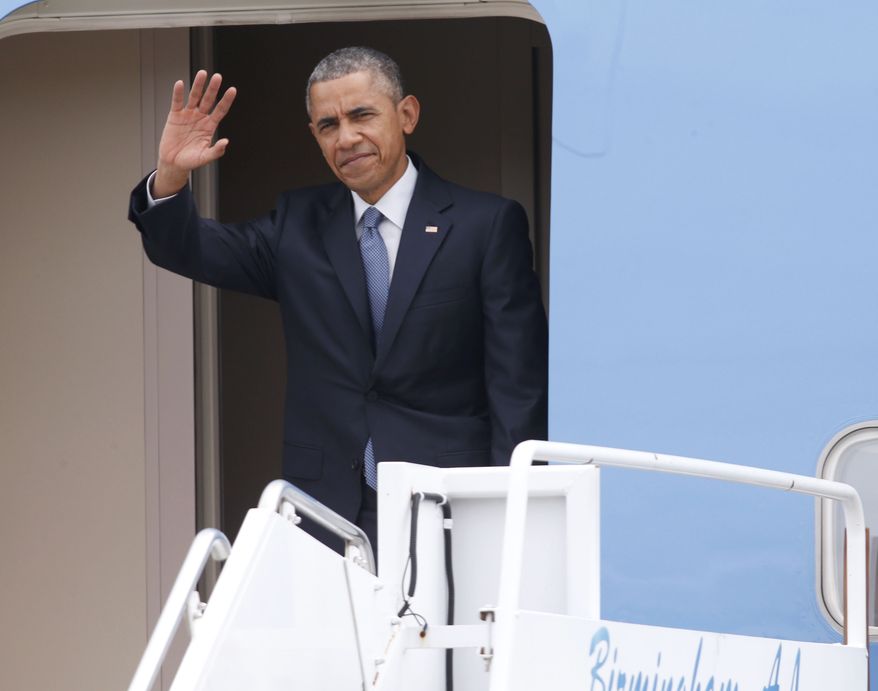 President Barack Obama waves from Air Force One upon his arrival at Birmingham-Shuttlesworth International Airport, Thursday, March 26, 2015, in Birmingham, Ala. The president will speak at Lawson State Community College, about the economy.  (AP Photo/ Hal Yeager)
