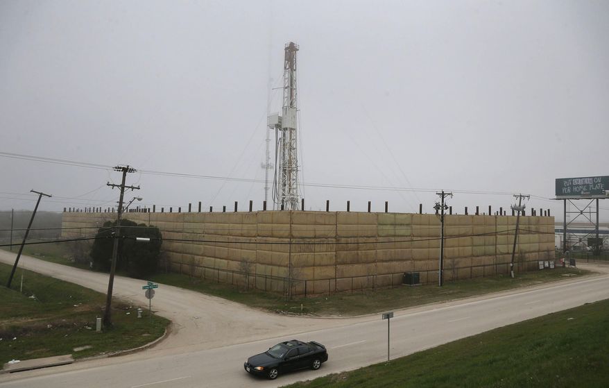In this photo taken on Thursday, March 19, 2015, a vehicle passes by the one remaining Barnett Shale drilling rig, along Loop 820 in east in Fort Worth, Texas. In October 2008, there were about 200 drilling rigs searching primarily for natural gas in the Barnett Shale. But by two weeks ago, there was only one rig reportedly working in the Barnett. (AP Photo/The Fort Worth Star-Telegram, Rodger Mallison) MAGS OUT; (FORT WORTH WEEKLY, 360 WEST); INTERNET OUT