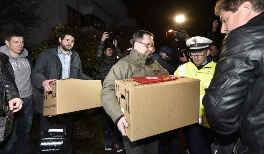 Investigators carry boxes from the apartment of Germanwings airliner jet co-pilot Andreas Lubitz, in Duesseldorf, Germany, Thursday March 26, 2015. On Thursday, French prosecutors said Lubitz, the co-pilot of Germanwings Flight 9525, "intentionally" crashed the jet into the side of a mountain Tuesday in the French Alps. (AP Photo/Martin Meissner)