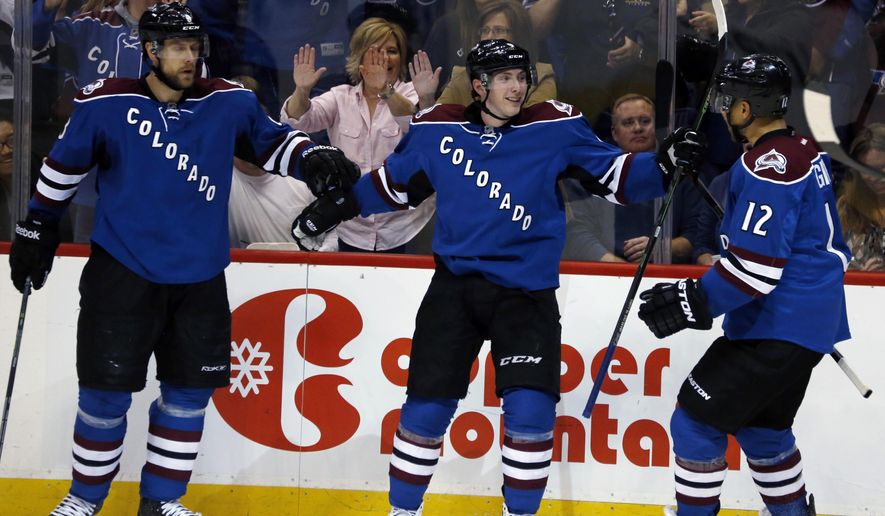 Colorado Avalanche center Matt Duchene, center, celebrates his goal with defenseman Jan Hejda, left, of the Czech Republic, and right wing Jarome Iginla in the second period of an NHL hockey game against the Buffalo Sabres, Saturday, March 28, 2015, in Denver. (AP Photo/David Zalubowski)