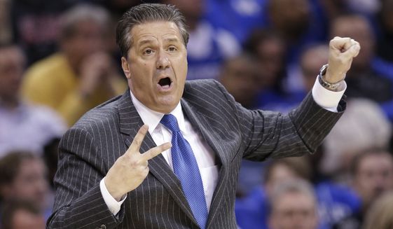 Kentucky coach John Calipari signals to his team during the first half of a college basketball game against Notre Dame in the NCAA men&#39;s tournament regional finals, Saturday, March 28, 2015, in Cleveland. (AP Photo/Tony Dejak)