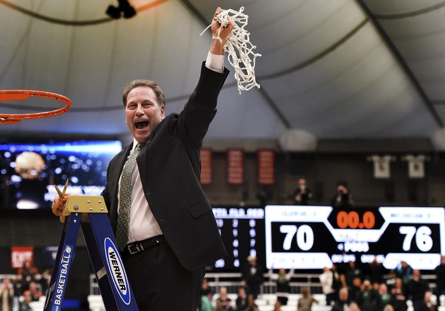 Michigan State coach Tom Izzo holds up the net after his team defeated Louisville 76-70 in overtime in the NCAA men's college basketball tournament East Regional in Syracuse, N.Y., Sunday, March 29, 2015. (AP Photo/Post-Standard, Kevin Rivoli)