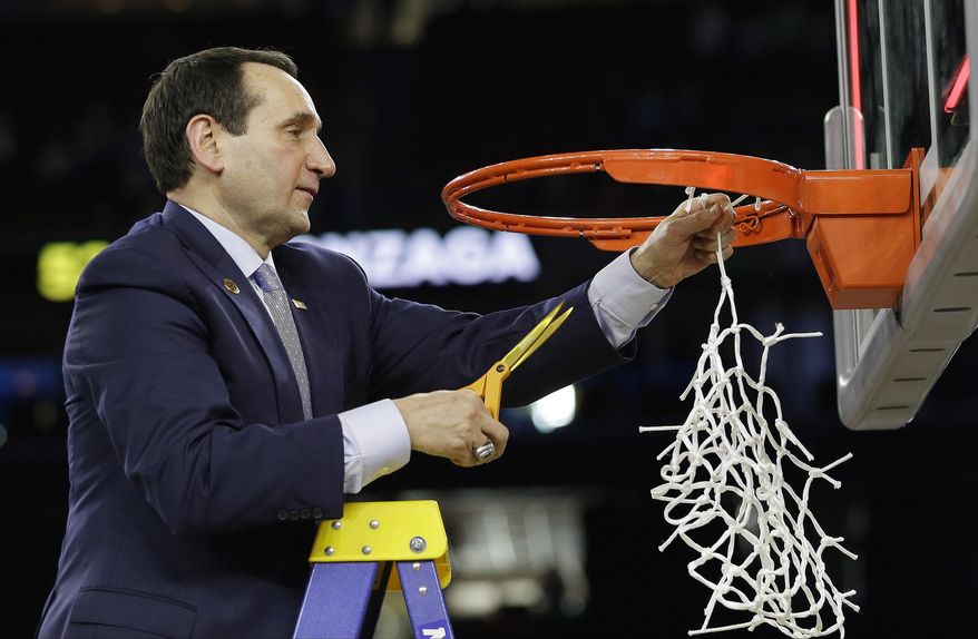 Duke head coach Mike Krzyzewski cuts down the net after a college basketball regional final game against Gonzaga in the NCAA Tournament Sunday, March 29, 2015, in Houston. Duke won 66-52 to advance to the Final Four. (AP Photo/David J. Phillip)