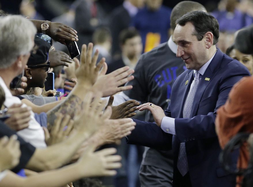 Duke head coach Mike Krzyzewski celebrates with fans after a college basketball regional final game against Gonzaga in the NCAA Tournament Sunday, March 29, 2015, in Houston. Duke won 66-52 to advance to the Final Four. (AP Photo/David J. Phillip)