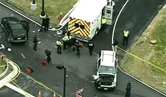 In this image made from video and released by WJLA-TV, authorities investigate the scene of a accident near a gate to Fort Meade, Md., on Monday, March 30, 2015. A spokesman at Fort Meade says two people are being treated for injuries at one of the gates of the sprawling Army installation near Baltimore. (AP Photo/WJLA-TV) MANDATORY CREDIT