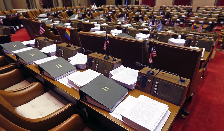 Budget bills sit on legislators&#39; desks in the Assembly Chamber at the state Capitol on Monday, March 30, 2015, in Albany, N.Y. Leaders in the Assembly and the Senate and Gov. Andrew Cuomo announced late Sunday night that they had reached a deal on the $142 billion state budget that includes a big boost in education funding. The spending plan that&#39;s due to be in place by Wednesday also includes enhanced ethics rules for legislators and several of Cuomo&#39;s proposed education reforms, which have been fiercely opposed by teacher unions. (AP Photo/Mike Groll)