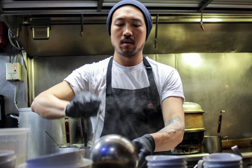Howard Chang, head chef at Toki Underground, serves up to 180 gallons of broth before the end of a busy night at his 20-seat ramen shop. (Photographs by Elizabeth Kennedy/Special to The Washington Times)