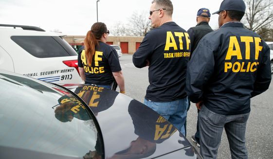 ATF agents gather in a parking lot where media have been asked to gather, down the road from the entrance to Ft. Meade after a vehicle rammed a gate to the National Security Agency, Monday, March 30, 2015 in Fort Meade, Md.  One person was killed in a firefight that erupted Monday after a car with two people tried to ram a gate at the Fort Meade, Md., military base near a gate to the National Security Agency, according to preliminary reports cited by two U.S. officials.  (AP Photo/Andrew Harnik)
