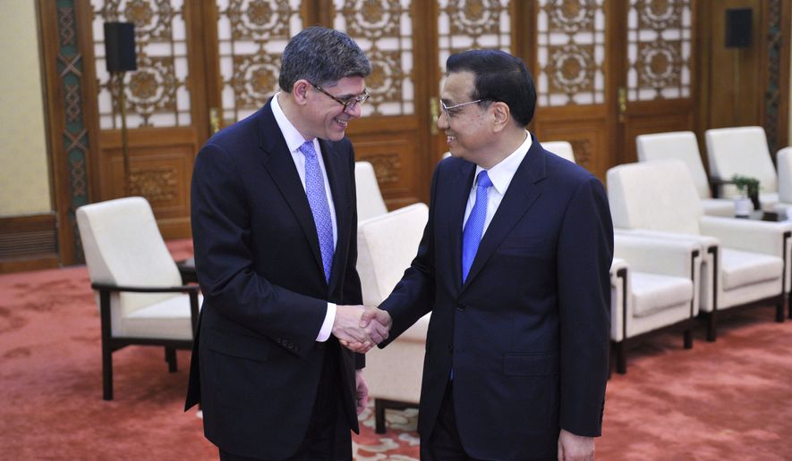 U.S. Treasury Secretary Jacob Lew, left, shakes hands with Chinese Premier Li Keqiang before a meeting at the Great Hall of the People in Beijing, China, on Monday, March 30, 2015. Lew said he pressed Chinese leaders Monday over proposed curbs on the use of foreign security products by banks and other restrictions on access to China&#39;s technology market. (AP Photo/Parker Song, Pool)