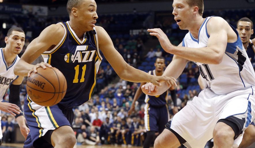 Utah Jazz’s Dante Exum, left, of Australia, drives as Minnesota Timberwolves’ Justin Hamilton defends in the first quarter of an NBA basketball game, Monday, March 30, 2015, in Minneapolis. (AP Photo/Jim Mone)