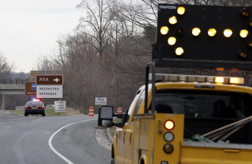 A Maryland State Police cruiser sits at a blocked southbound entrance on the Baltimore-Washington Parkway that accesses the National Security Agency, Monday, March 30, 2015, in Fort Meade, Md. A spokeswoman at Fort Meade says two people have been injured near a gate to the NSA. (AP Photo/Patrick Semansky)