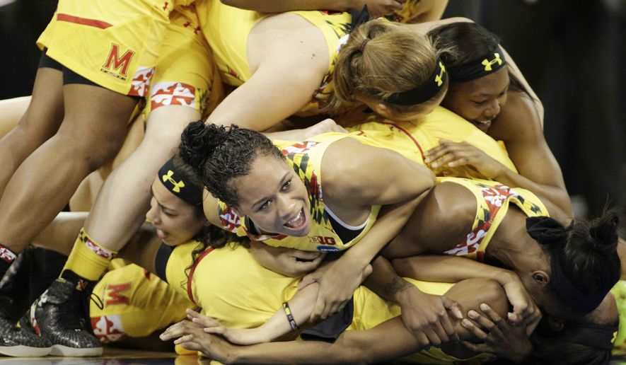 Maryland&#39;s Aja Ellison, center, and her teammates celebrate after winning a women&#39;s college basketball regional final game against Tennessee in the NCAA tournament, Monday, March 30, 2015, in Spokane, Wash. Maryland won 58-48. (AP Photo/Young Kwak)