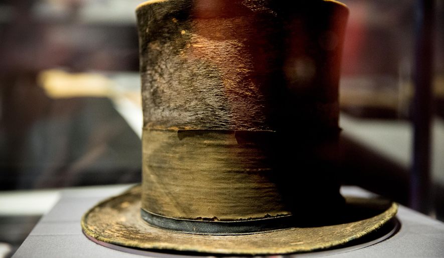 FILE - In this March 17, 2015 file photo, President Abraham Lincoln's top hat from the night of his assassination is on display at a new exhibit entitled "Silent Witnesses: Artifacts of the Lincoln Assassination" at the Ford's Center for Education and Leadership across the street from the historic Ford's Theatre where President Abraham Lincoln was killed, in Washington. The exhibit is open to the public until May 25, and coincides with the 150th anniversary of the Lincoln assassination on April 14. (AP Photo/Andrew Harnik, File)