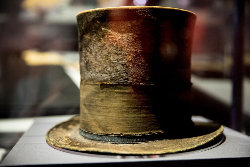 FILE - In this March 17, 2015 file photo, President Abraham Lincoln's top hat from the night of his assassination is on display at a new exhibit entitled "Silent Witnesses: Artifacts of the Lincoln Assassination" at the Ford's Center for Education and Leadership across the street from the historic Ford's Theatre where President Abraham Lincoln was killed, in Washington. The exhibit is open to the public until May 25, and coincides with the 150th anniversary of the Lincoln assassination on April 14. (AP Photo/Andrew Harnik, File)