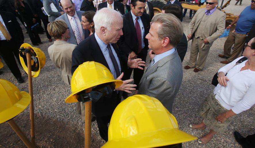 Arizona Sen. John McCain, left, talks with Raytheon Missile Systems president Taylor Lawrence during a groundbreaking ceremony for construction of the new Aerospace Parkway south of Raytheon Missile Systems on East Hughes Access Road on Tuesday, March 31, 2015, in Tucson, Ariz. The realignment moves Hughes Access Road 2,500 feet to the south, allowing room for a second runway to be built at Tucson International Airport. (AP Photo/Arizona Daily Star, Mike Christy)
