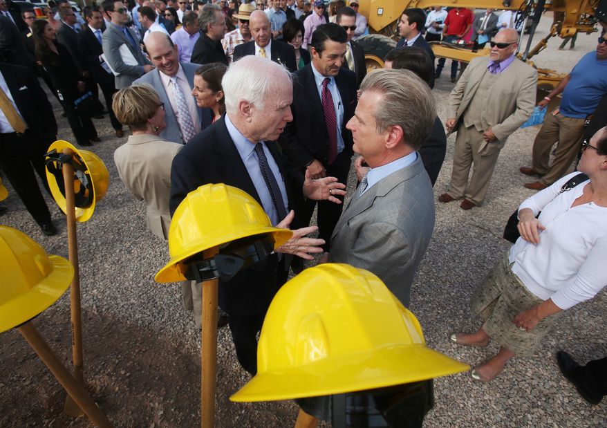 Arizona Sen. John McCain, left, talks with Raytheon Missile Systems president Taylor Lawrence during a groundbreaking ceremony for construction of the new Aerospace Parkway south of Raytheon Missile Systems on East Hughes Access Road on Tuesday, March 31, 2015, in Tucson, Ariz. The realignment moves Hughes Access Road 2,500 feet to the south, allowing room for a second runway to be built at Tucson International Airport. (AP Photo/Arizona Daily Star, Mike Christy)