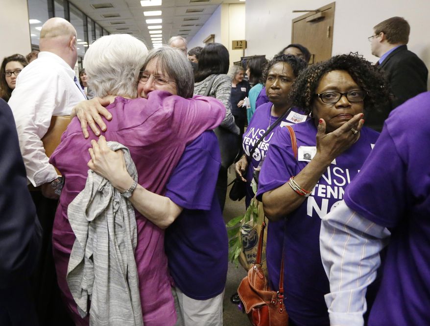 Supporters of Gov. Bill Haslam's Insure Tennessee proposal console one another after attending a meeting of the Senate Commerce Committee to hear debate on the measure Tuesday, March 31, 2015, in Nashville, Tenn. The proposal to extend health coverage to about 280,000 low-income Tennesseans was defeated 6-2. (AP Photo/Mark Humphrey)