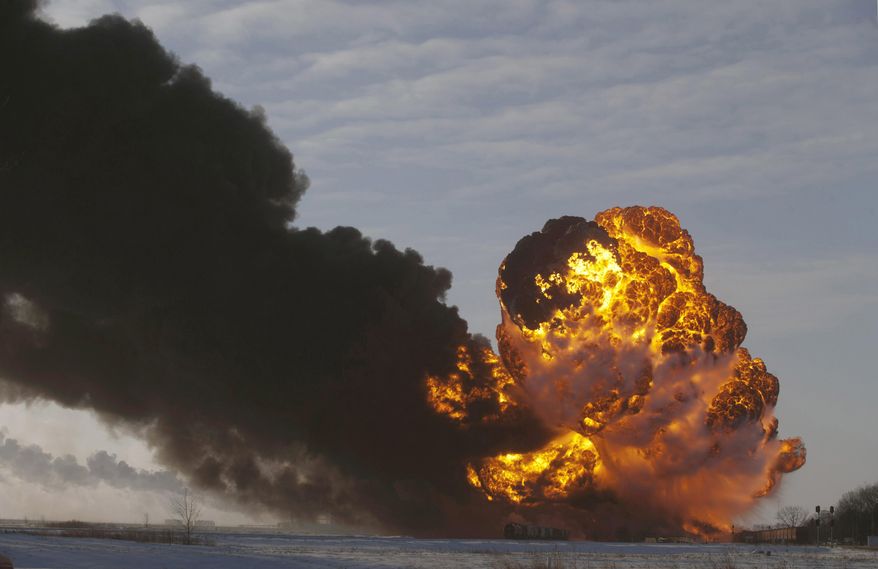 FILE - In this Dec. 30, 2013 file photo, a fireball goes up at the site of an oil train derailment in Casselton, N.D. On Tuesday, March 31, 2015, Bryan Thompson, of Fargo, N.D., the engineer of the oil tanker train involved in the derailment, filed a complaint against BNSF Railway, accusing the railroad of negligence. Thompson says BNSF failed to properly inspect and maintain its equipment and failed to warn him of the dangers of hauling explosive oil tank railcars. (AP Photo/Bruce Crummy, File)