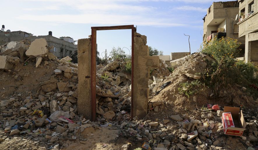 An empty frame doorway is seen standing on the rubble of a destroyed building that was damaged in last summer's Israel-Hamas war, without a door painting, presumably painted by British street graffiti artist Banksy, east of Jebaliya, in the northern Gaza Strip, Tuesday, March 31, 2015. Artworks by the elusive British graffiti artist Banksy are typically sold for hundreds of thousands of dollars, but in the Gaza Strip a local painter has succeeded in purchasing a Banksy original for less than $200. The popular street artist is believed to have sneaked into Gaza in February, leaving behind four murals including one drawn on a metal door that depicted a Greek goddess cowering against the rubble of a destroyed house. The painting of the goddess Niobe, titled "Bomb Damage," was drawn on the lone remaining part of a two-story house belonging to the Dardouna family in Jabaliya, northern Gaza Strip. (AP Photo/Adel Hana)