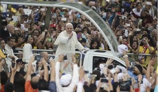 Crowds cheer as Pope Francis passes by during his meeting with the youth at the University of Santo Tomas in Manila, Philippines on Sunday, Jan. 18, 2015. Francis drew a huge crowd earlier Sunday when he addressed young people at Manila&#x27;s Catholic university, coming close to tears himself when he heard two young children speak of their lives growing up poor and on the streets. (AP Photo/Aaron Favila)