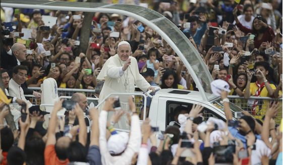 Crowds cheer as Pope Francis passes by during his meeting with the youth at the University of Santo Tomas in Manila, Philippines on Sunday, Jan. 18, 2015. Francis drew a huge crowd earlier Sunday when he addressed young people at Manila&#39;s Catholic university, coming close to tears himself when he heard two young children speak of their lives growing up poor and on the streets. (AP Photo/Aaron Favila)