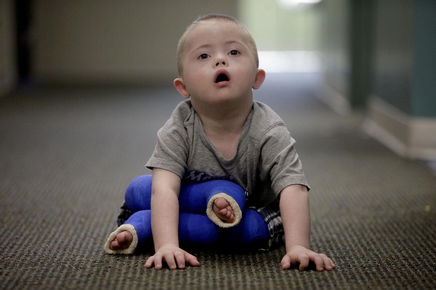In this photo taken April 19, 2012, Cooper, who has Down syndrome and autism, waits to see a dentist for the first time after getting new casts on his legs to correct bilateral clubfoot at Dell Children's Medical Center in Austin, Texas. (AP Photo/The San Antonio Express-News, Lisa Krantz) RUMBO DE SAN ANTONIO OUT; NO SALES **FILE**