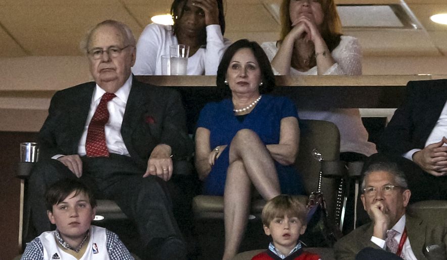 Tom Benson, Behind child, the owner of the New Orleans Pelicans and Saints,  and his wife Gayle Benson attend the NBA basketball game against the Minnesota Timberwolves  in New Orleans, Sunday, March 29, 2015. Bottom right is Greg Bensel, the New Orleans Saints vice president of communications. The Pelicans won 110-88. (AP Photo/Scott Threlkeld)
