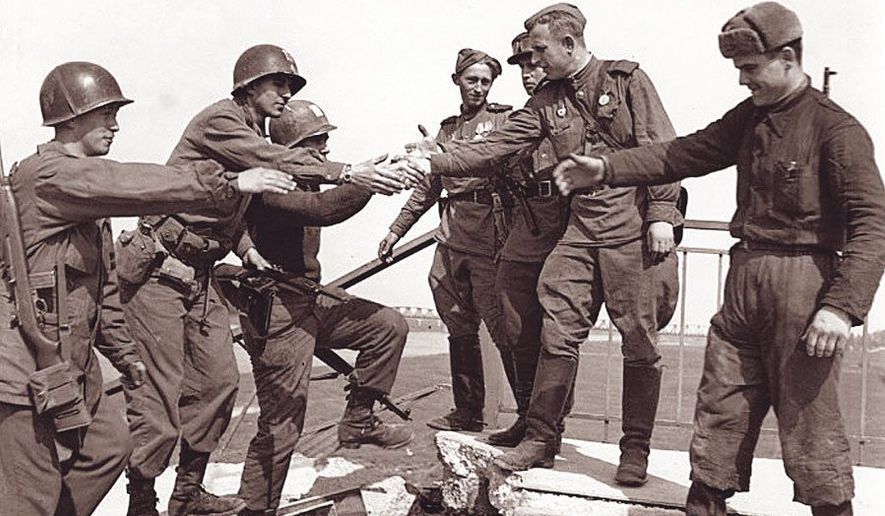 U.S. and Soviet Russian troops meet at the Elbe river in 1945.          U.S. Army photo