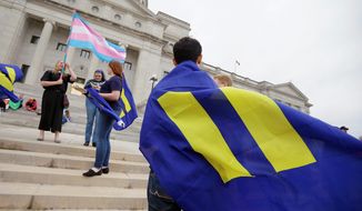 capitol offense: Demonstrators take to the steps of the Arkansas State Capitol in Little Rock in protest of homosexual discriminatory language in the Religious Freedom Restoration Act. Changes were signed into law by Gov. Asa Hutchinson. (Associated Press photographs)
