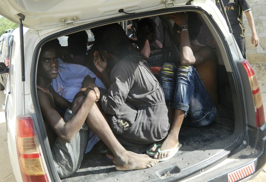 Students of the Garissa University College take shelter in a vehicle after fleeing from an attack by gunmen in Garissa, Kenya, Thursday, April 2, 2015. Gunmen attacked the university early Thursday, shooting indiscriminately in campus hostels. Police and military surrounded the buildings and were trying to secure the area in eastern Kenya, police officer Musa Yego said. (AP Photo)