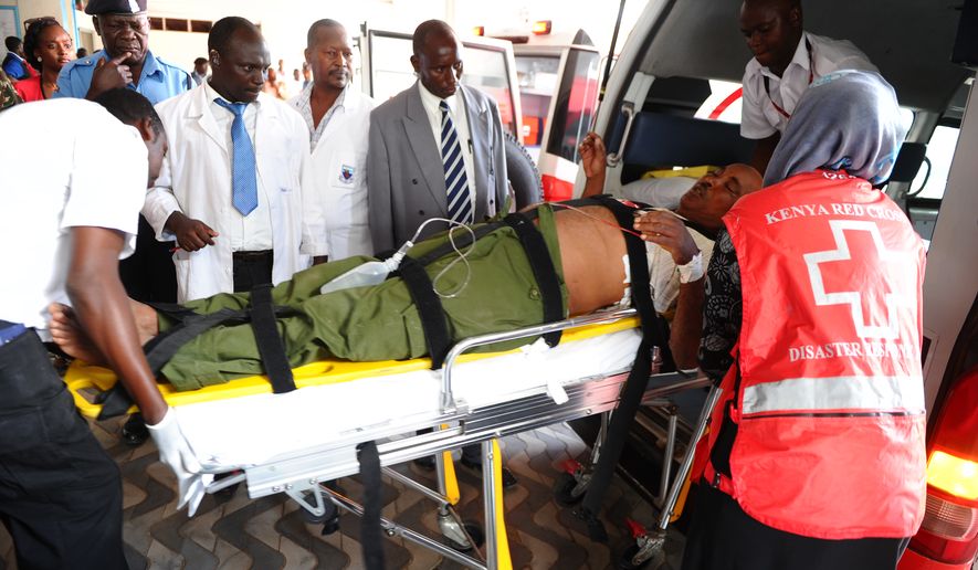 Medics help an injured person at Kenyatta National Hospital in Nairobi, Kenya, Thursday, April , 2, 2015 , after an attack by gunmen at Garissa University College. Al-Shabab gunmen targeted Christians, killing at least 15 people and wounding 60 others. (AP Photo)