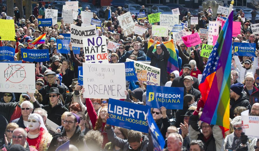 Thousands of opponents of Indiana Senate Bill 101, the Religious Freedom Restoration Act, rally against the legislation on the lawn of the Indiana State House. (Associated Press)