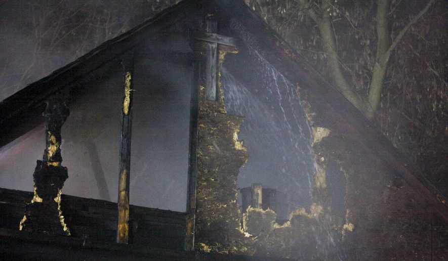 Water is sprayed on a barn by South County Fire Authority personnel during a fire in Schoolcraft, Mich., on Thursday, April 2, 2015. The fire that destroyed two barns left five young goats dead. Crews responded late Thursday to the fire near Schoolcraft and found smoke and flames spreading from one barn to the other one. No injuries to people were reported. (AP Photo/Kalamazoo Gazette-MLive Media Group, Crystal Vander Weit) ALL LOCAL TELEVISION OUT; LOCAL TELEVISION INTERNET OUT