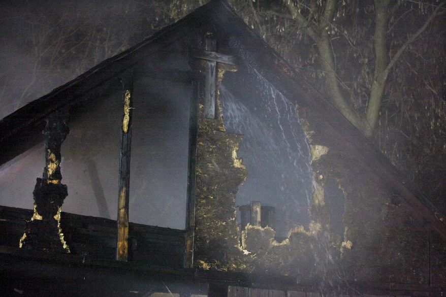 Water is sprayed on a barn by South County Fire Authority personnel during a fire in Schoolcraft, Mich., on Thursday, April 2, 2015. The fire that destroyed two barns left five young goats dead. Crews responded late Thursday to the fire near Schoolcraft and found smoke and flames spreading from one barn to the other one. No injuries to people were reported. (AP Photo/Kalamazoo Gazette-MLive Media Group, Crystal Vander Weit) ALL LOCAL TELEVISION OUT; LOCAL TELEVISION INTERNET OUT