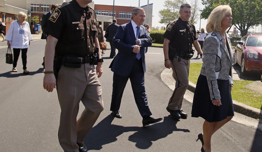 Susan Hubbard leads the way to the car for Alabama Speaker of the House Mike Hubbard after a hearing at the Lee County Justice Center on Friday, April 3, 2015 in Opelika, Ala.(AP Photo/Opelika-Auburn News, Todd J. Van Emst)