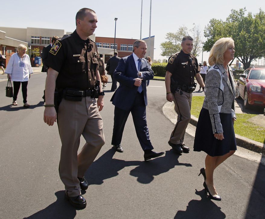 Susan Hubbard leads the way to the car for Alabama Speaker of the House Mike Hubbard after a hearing at the Lee County Justice Center on Friday, April 3, 2015 in Opelika, Ala.(AP Photo/Opelika-Auburn News, Todd J. Van Emst)
