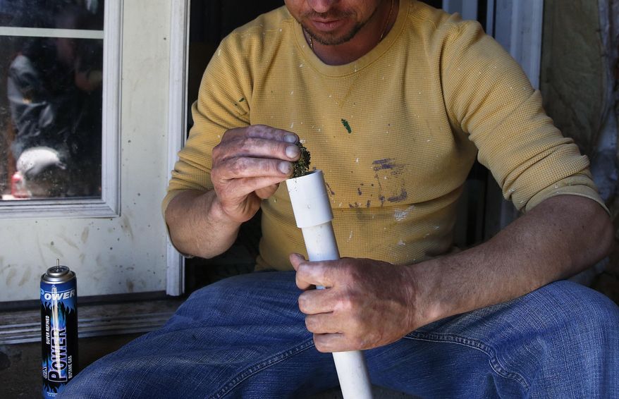 In this May 1, 2014 photo, a man who suffered severe burns to 12 percent of his body when butane fumes ignited while he was making hash oil at home, demonstrates how he made the marijuana concentrate, at his home in Denver. Alarmed by a rash of explosions caused by amateur hash production, Colorado and Washington lawmakers are considering limits on making the marijuana concentrate at home. (AP Photo/Brennan Linsley)