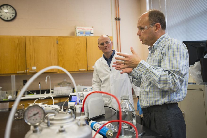 ADVANCE FOR MONDAY APRIL 6 AND THEREAFTER - In a Wednesday, March 4, 2015 photo, David Ladner, left, and Scott Husson explain the research being conducted at Clemson University they call "water-energy nexus". Whenever unsalty water meets up with its saline cousin, the fresh water tries with all its might to suck in the salt. At Clemson University, scientists are working to harness this innate property of water to make electricity. Their idea is to use the electricity to turn saltwater into fresh water.(AP Photo/The Greenville News, Mykal Mceldowney) NO SALES