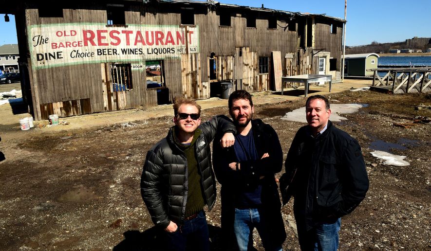 ADVANCE FOR USE SATURDAY, APRIL 4 - In this photo taken Monday, March 23, 2015, Miles Pincus, left, Alexander Pincus, center, and local historian Robert Greenberg posse in front of the shuttered Old Barge Restaurant on Front Street in New Haven, Conn. The restaurant has been gifted by Lisa Fitch, of the Quinnipiac River Marina, to the non-profit Maritime Foundation in New York, where it will be transported in pieces, restored and reassembled. The Old River Restaurant was originally a working oyster barge. (AP Photo/New Haven Register, Peter Hvizdak)