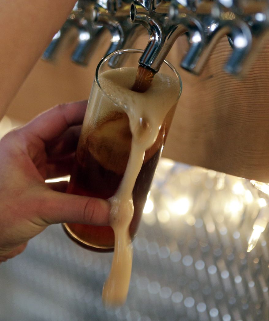 In this Friday, March 20, 2015 photo, a maple amber beer is poured at Chatham Brewing in Chatham, N.Y. (AP Photo/Mike Groll)