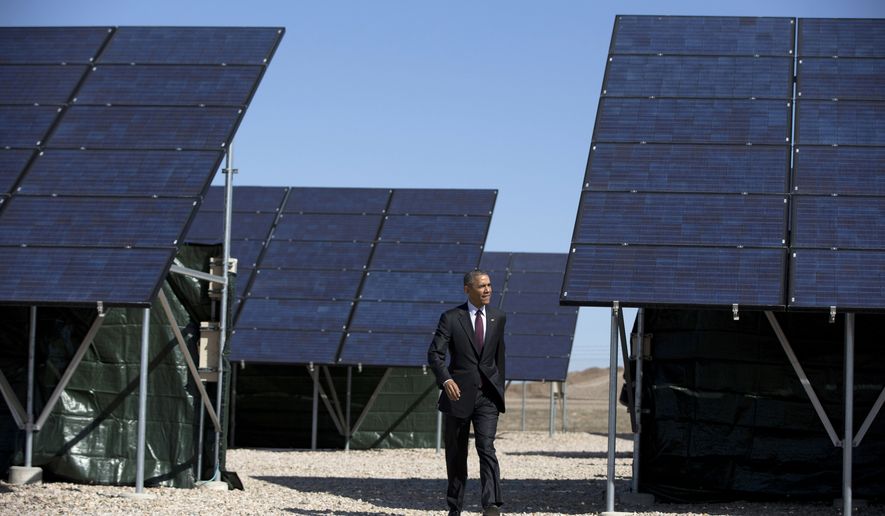 President Barack Obama walks through a solar array at Hill Air Force Base, Utah, Friday, April 3, 2015, to speak about clean energy and the jobs numbers. (AP Photo/Carolyn Kaster)