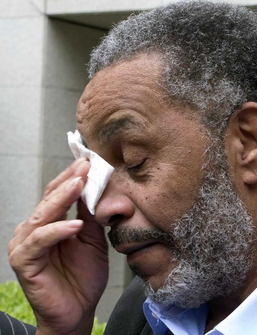 Anthony Ray Hinton wipes away tears after greeting friends and relatives upon leaving the Jefferson County jail, Friday, April 3, 2015, in Birmingham, Ala. Hinton spent nearly 30 years on Alabama's death row, and was set free Friday after prosecutors told a judge they won't re-try him for the 1985 slayings of two fast-food managers. (AP Photo/ Hal Yeager)