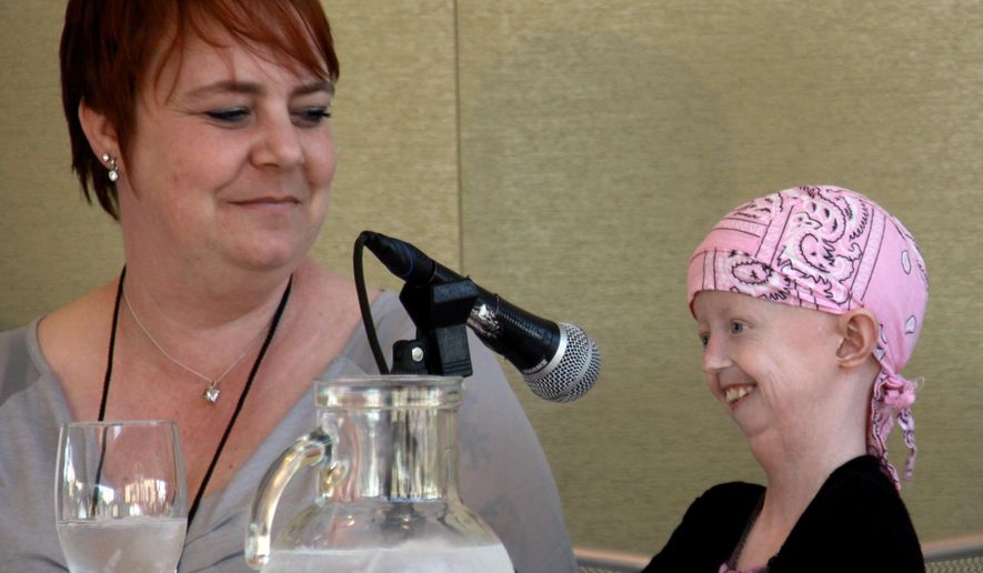 In this photo provided by the Progeria Research Foundation on Friday, April 3, 2015, Hayley Okines, right, talks during an interview with her mother Kerry. A campaigner who raised awareness of the rare genetic condition progeria, which causes those affected to age some eight times faster than average, has died at age 17. The U.S.-based Progeria Research Foundation said Hayley Okines, from East Sussex in England, died Thursday, April 2, 2015, at her home. It did not provide more details. (AP Photo/Progeria Research Foundation)