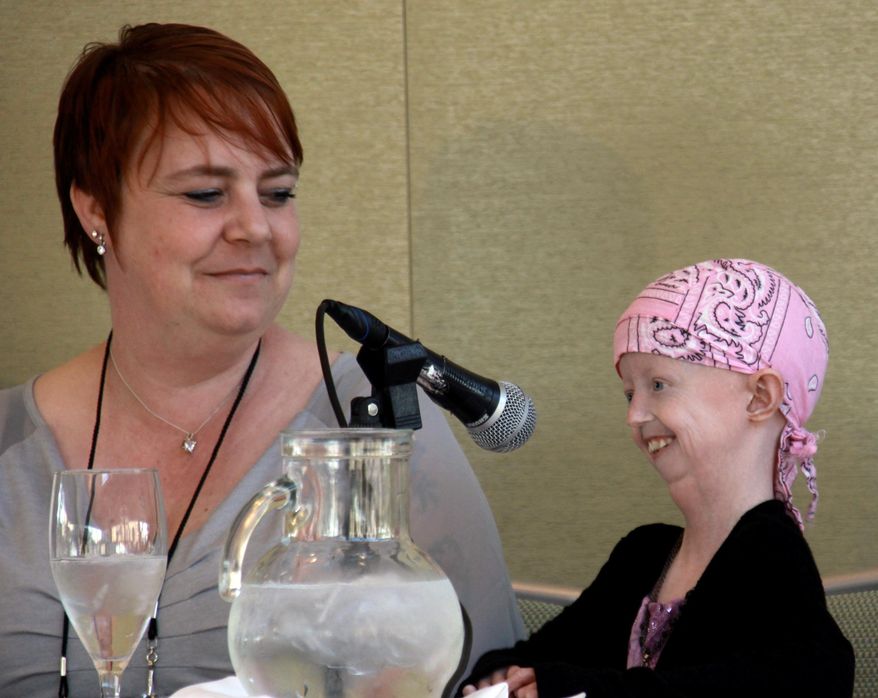 In this photo provided by the Progeria Research Foundation on Friday, April 3, 2015, Hayley Okines, right, talks during an interview with her mother Kerry. A campaigner who raised awareness of the rare genetic condition progeria, which causes those affected to age some eight times faster than average, has died at age 17. The U.S.-based Progeria Research Foundation said Hayley Okines, from East Sussex in England, died Thursday, April 2, 2015, at her home. It did not provide more details. (AP Photo/Progeria Research Foundation)